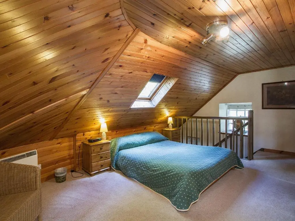 a bedroom with a bed in a attic at Tinkerbell in Balnaboth