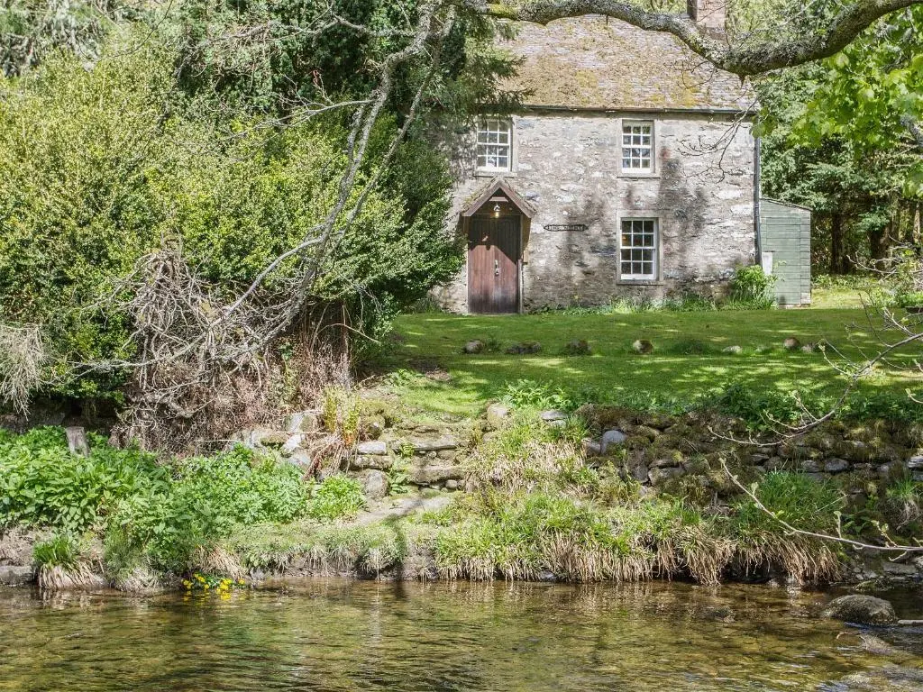 an old stone house next to a river at Gardener's Bothy in Balnaboth