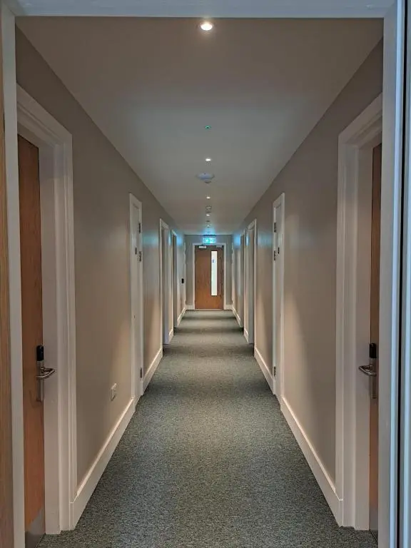 a hallway of an office building with a long corridor at An Spiris Accommodation at Dundreggan Rewilding Centre in Dundreggan