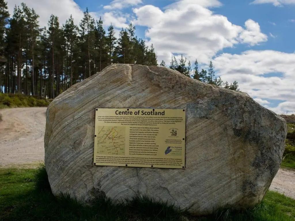 a large rock with a sign on top of it at Spectacular Mountain View Ecopod in Newtonmore
