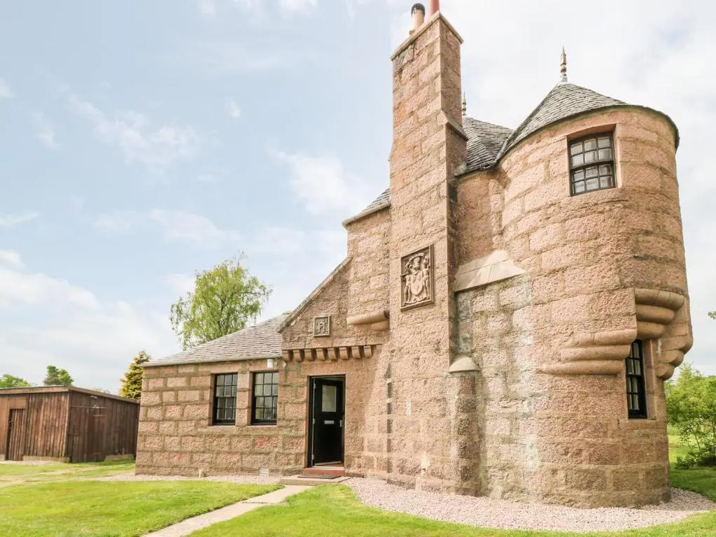 an old stone house with a chimney at Holly Leaf Cottage - Drum Castle Estate in Banchory