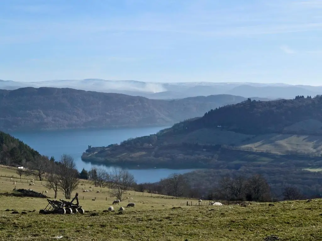 a person standing on a hill with a view of a lake at Burns Cottage in Drumnadrochit