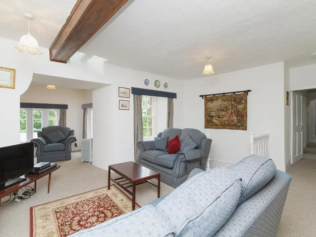 a living room with a couch and a tv at Symbister Suite in Turriff