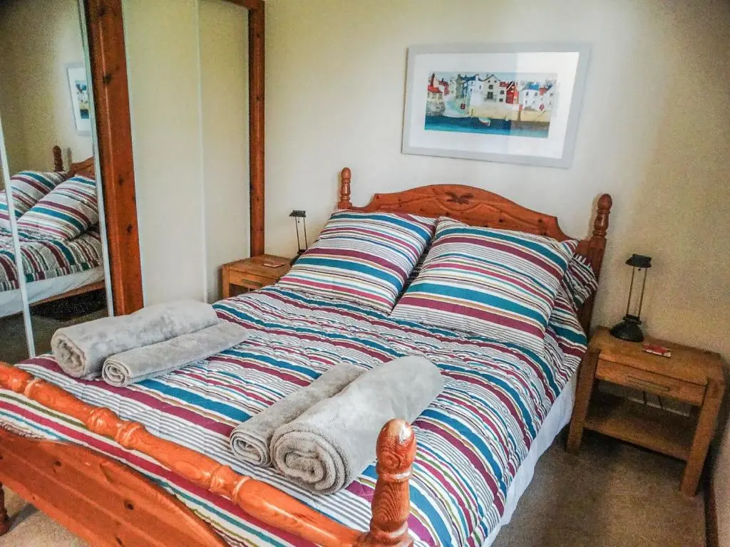 a bed with towels on it in a room at Scobach Lodge in Turriff