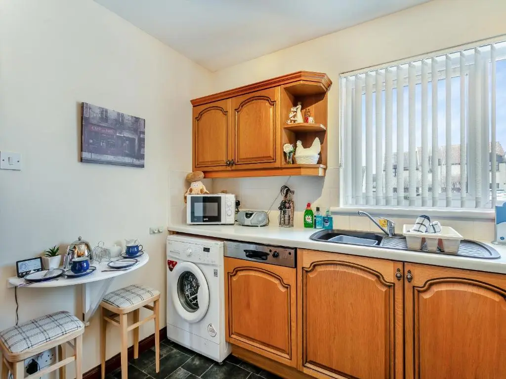 a kitchen with a sink and a washing machine at Ocean View - 28045 in Banff