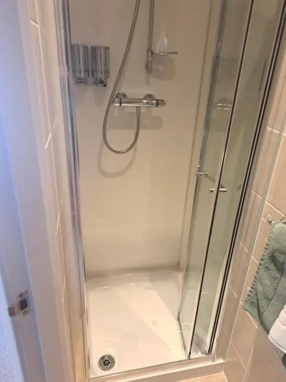 a shower with a glass shower stall in a bathroom at No 27 in Inverness