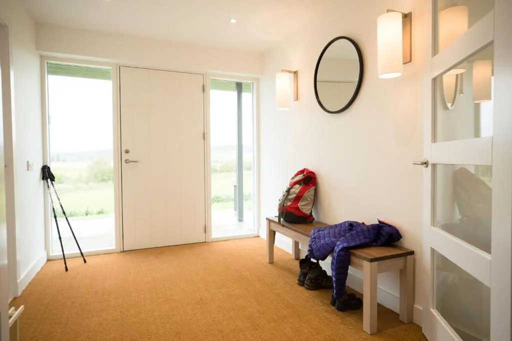 a hallway with a table and a mirror on the wall at Tomdhu Lodge - Seasgair Lodges in Boat of Garten