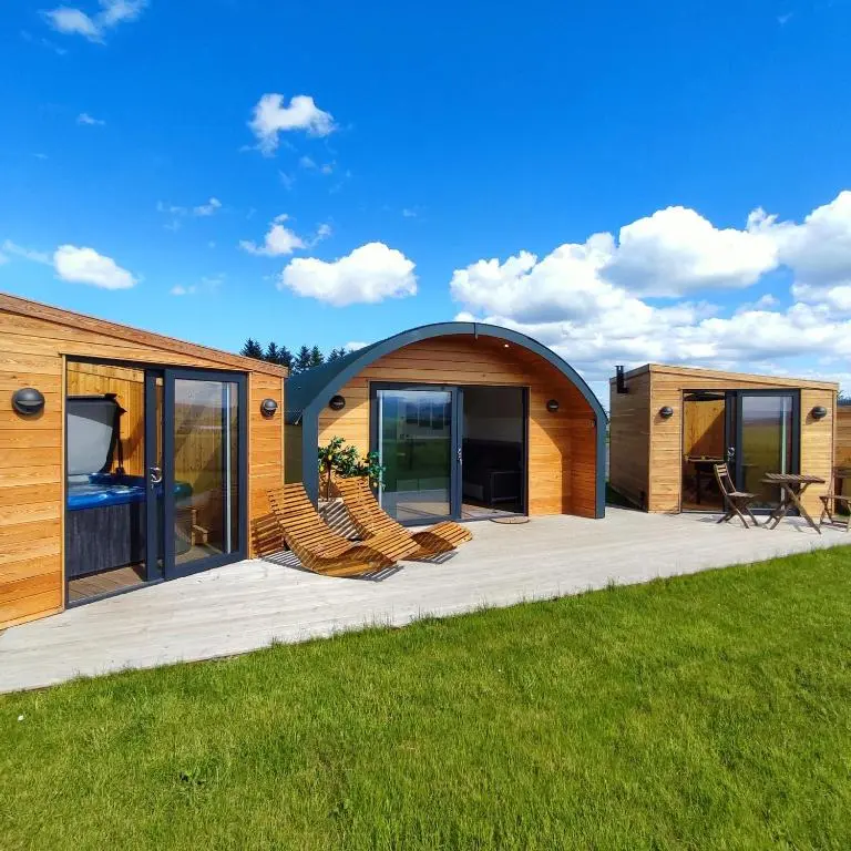 a house with a large deck with chairs on it at Ben Aigan in Keith