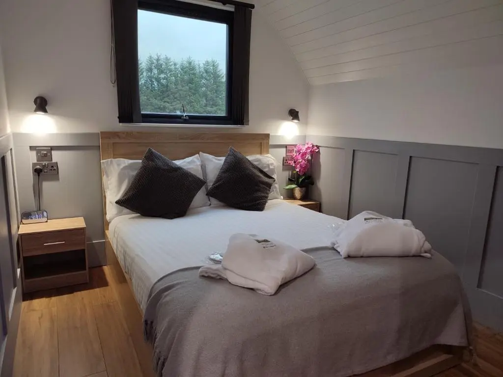 a bedroom with a bed with two pillows on it at Meikle Balloch in Keith
