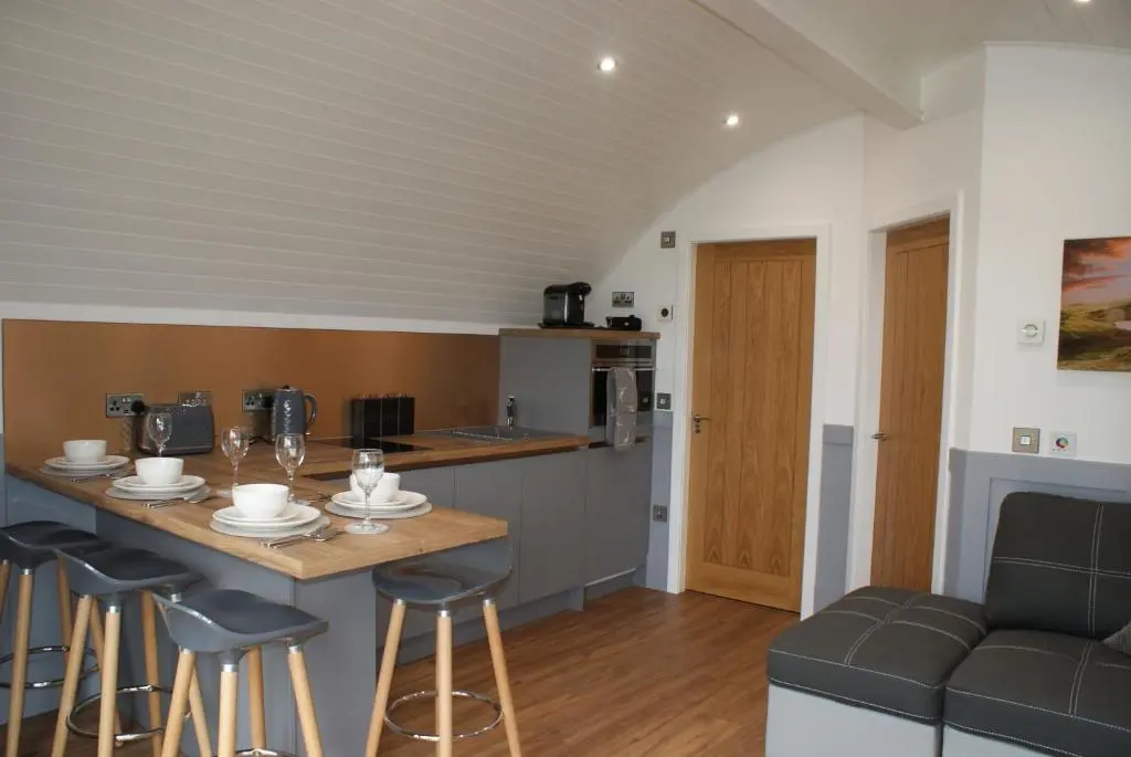 a kitchen and living room with a table and chairs at Ben Rinnes in Keith