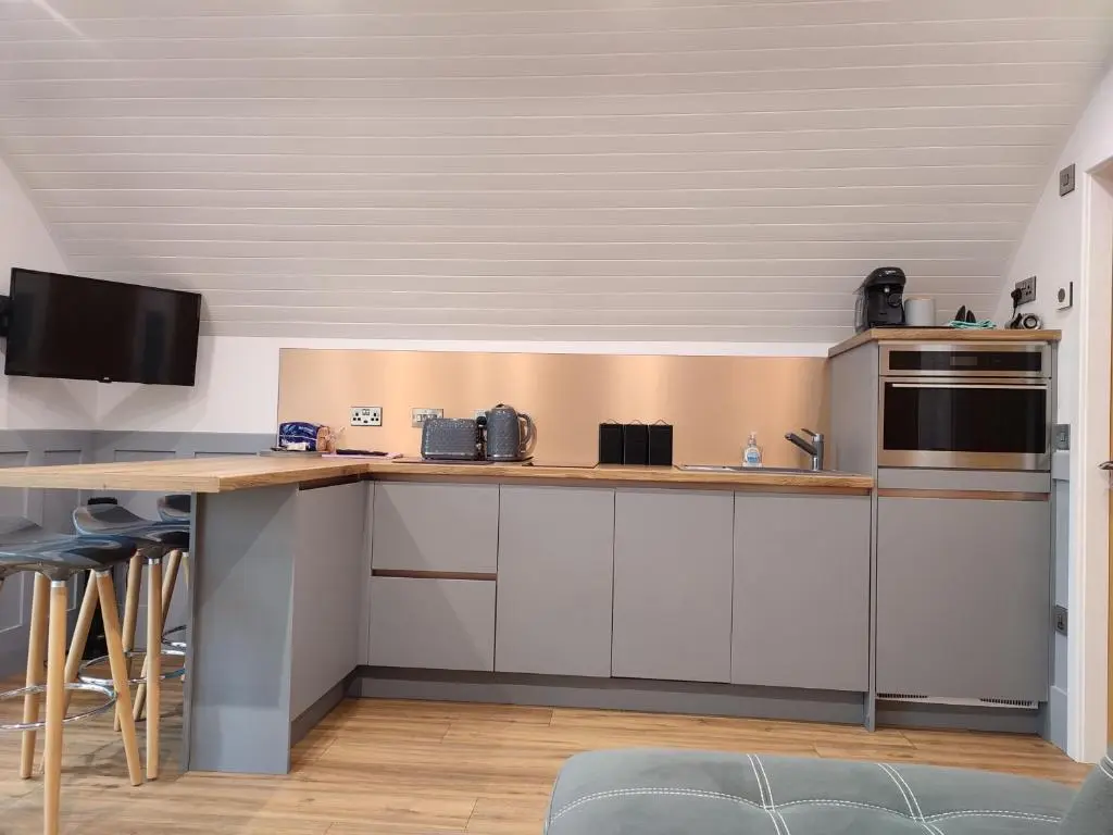 a kitchen with white cabinets and a counter top at Ben Rinnes in Keith