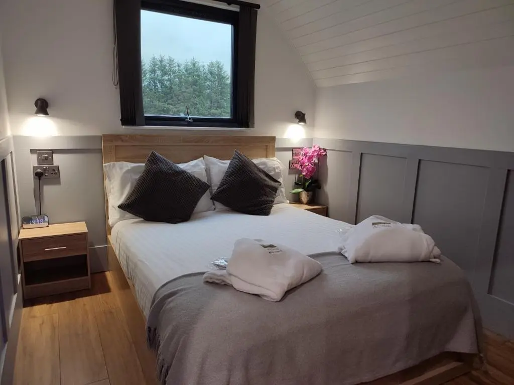 a bedroom with a bed with two pillows on it at Knockan in Keith