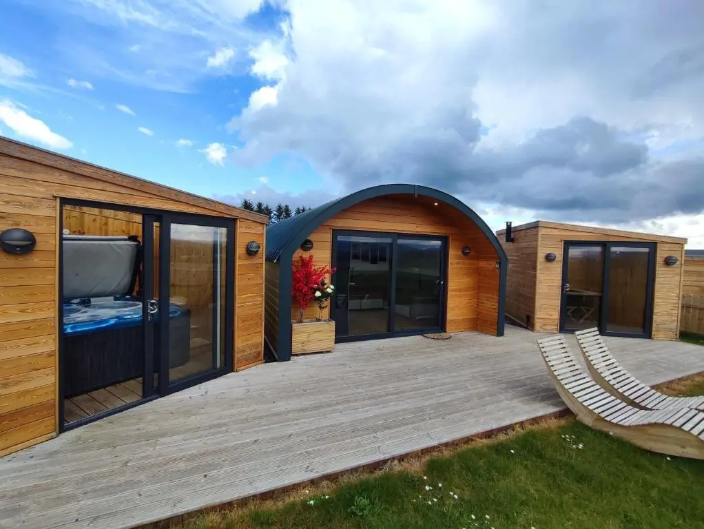 a house with a large deck with a tv on it at Knockan in Keith