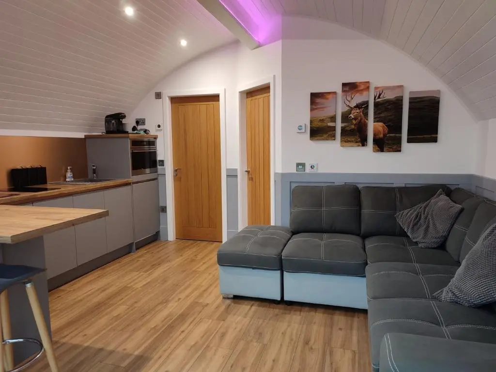 a living room with a couch and a kitchen at Knockan in Keith
