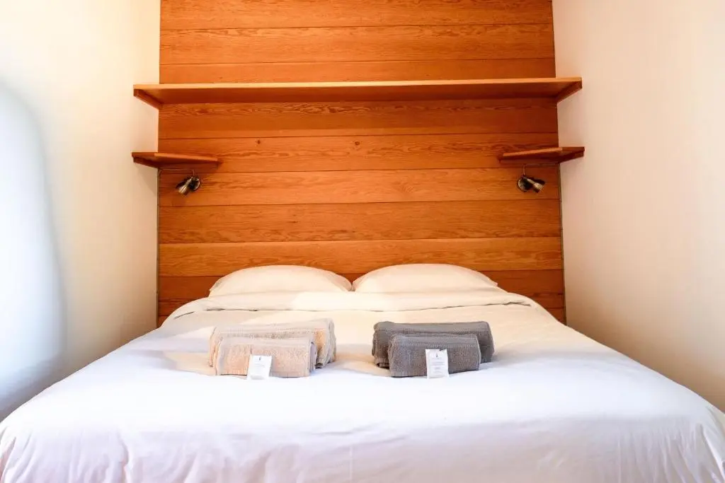 a bed with two towels on top of it at Marcassie Farm Lodges - Willow Studio in Forres