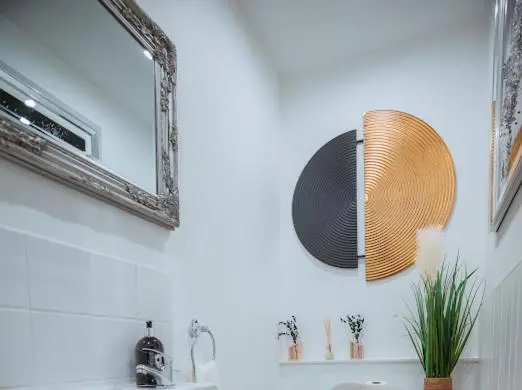 a bathroom with a mirror and a sink at Nairn View Guest House in Nairn
