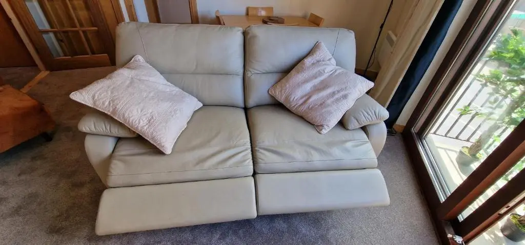 a white couch with two pillows in a living room at Colin Young Place in Nairn