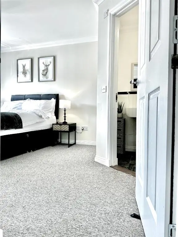 a white bedroom with a bed and a table at Riverview Apartment 2 bed, 2 bath, Free Parking / WiFi in Inverness
