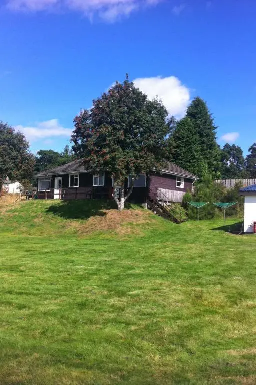 a house with a tree in the middle of a yard at Holiday Home Lochness by Interhome in Contin