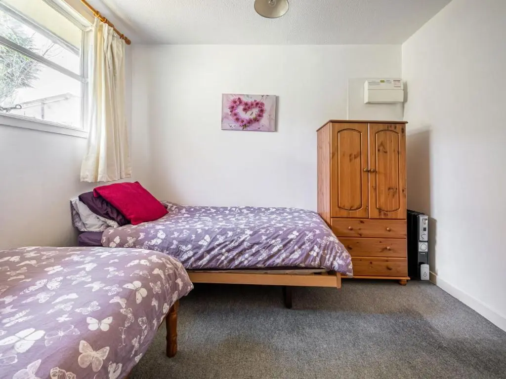 a bedroom with two beds and a wooden cabinet at Holiday Home Isle of Skye by Interhome in Contin