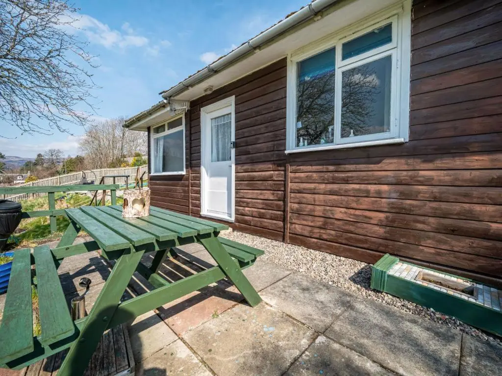 a picnic table outside of a tiny house at Holiday Home Isle of Skye by Interhome in Contin