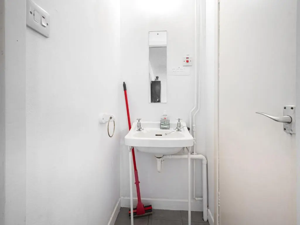 a white bathroom with a sink and a mirror at Holiday Home Isle of Skye by Interhome in Contin