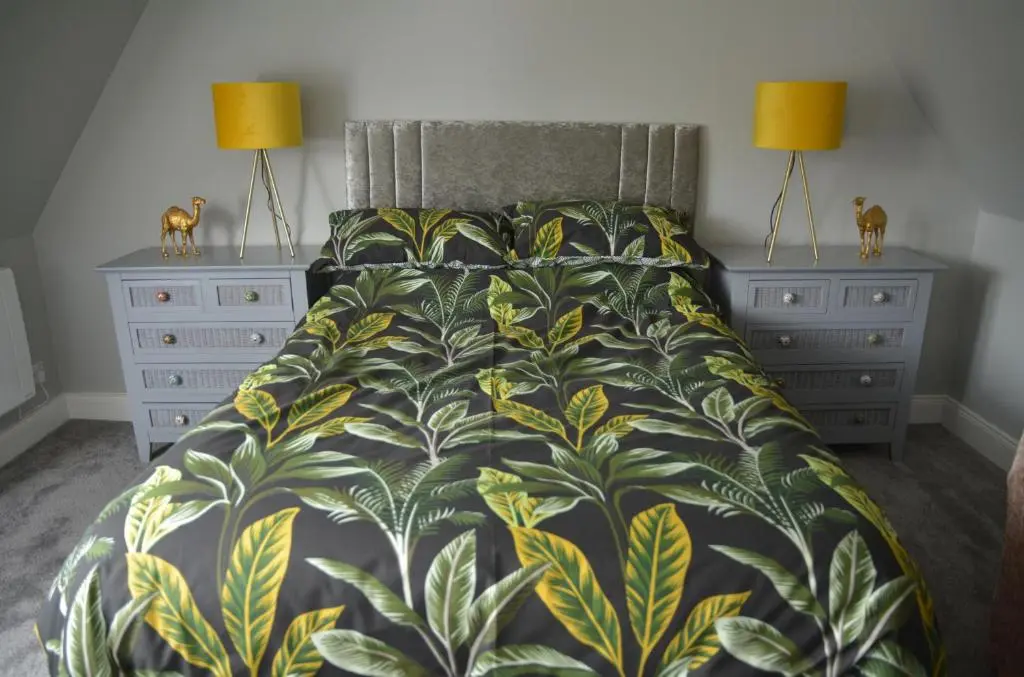 a bedroom with a bed and two night stands at St Duthus Hotel Apartment in Tain