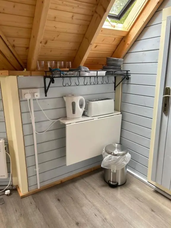 a small kitchen in a shed with a roof at 1Lochness glam lodges in Inverness