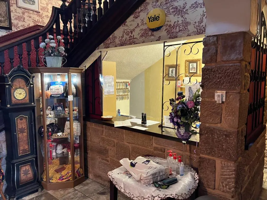 a store with a table and a clock in a room at Strathpeffer Hotel in Strathpeffer
