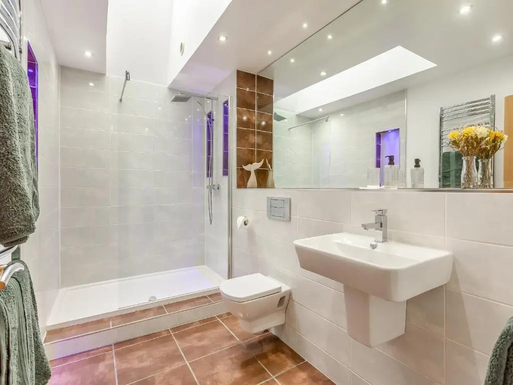 a bathroom with a sink and a toilet and a shower at The Bothy in Lochend