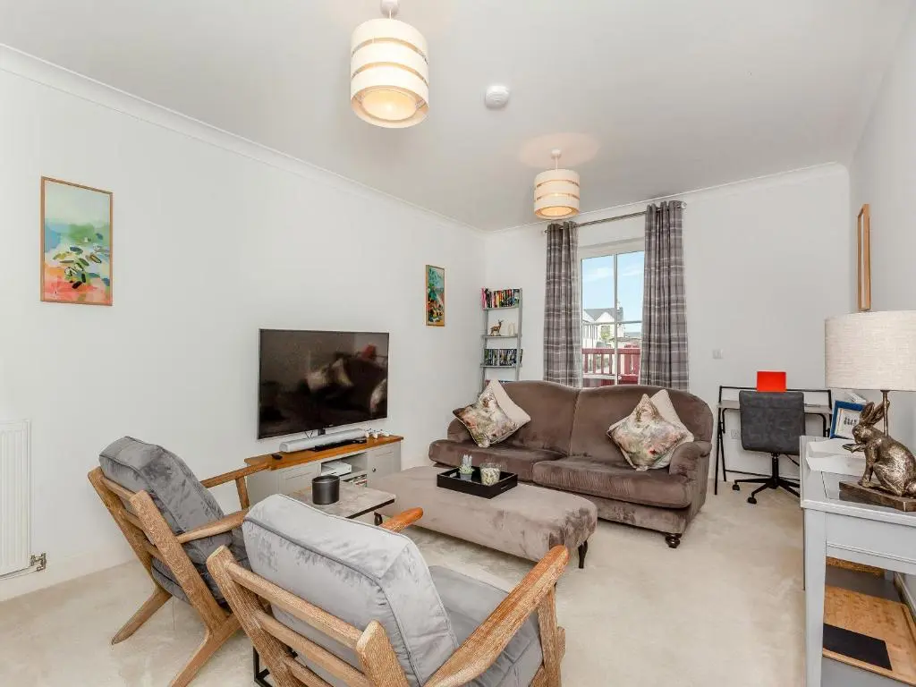 a living room with a couch and a tv at One The Loan in Croy