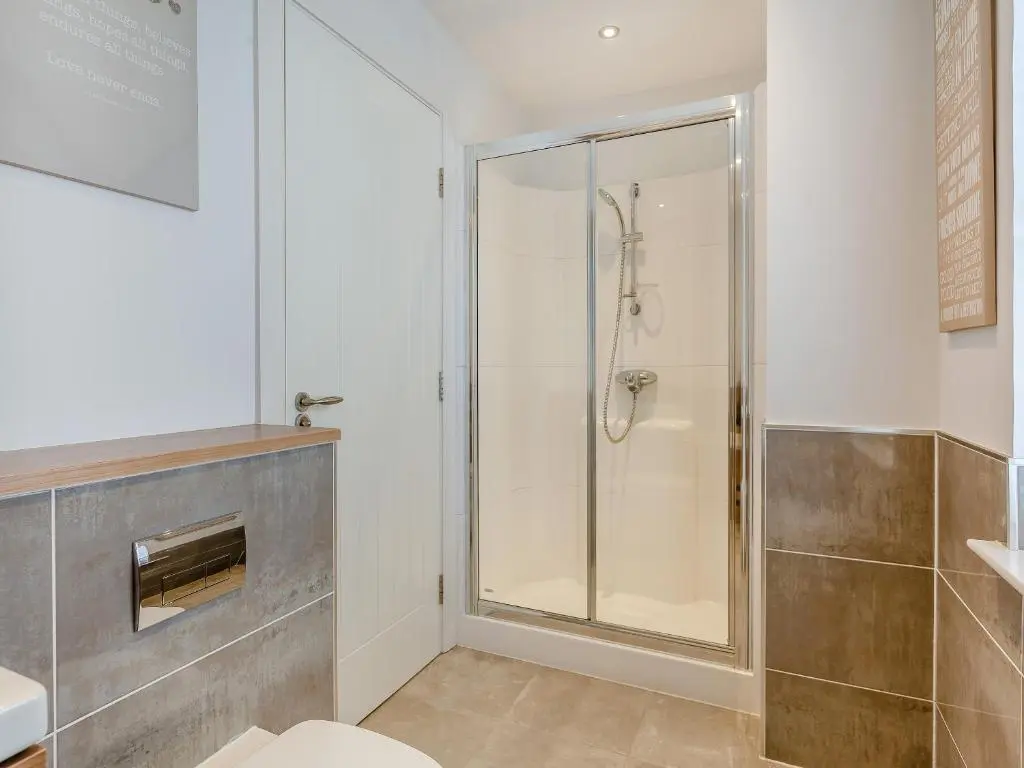 a bathroom with a shower with a glass door at One The Loan in Croy