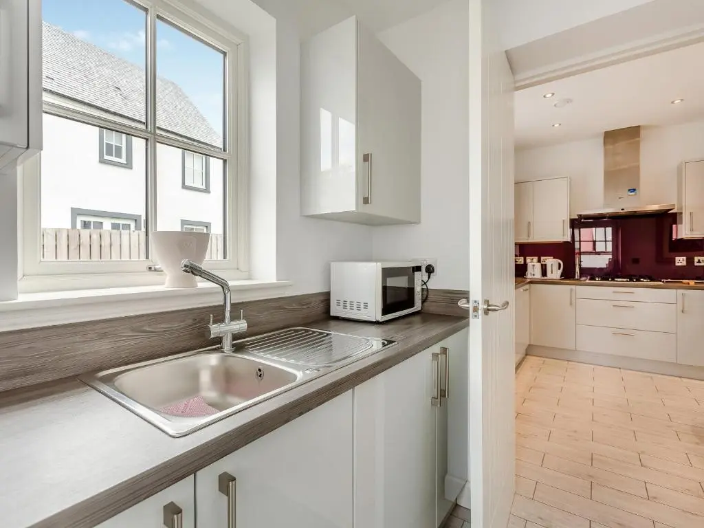 a kitchen with a sink and a window at One The Loan in Croy