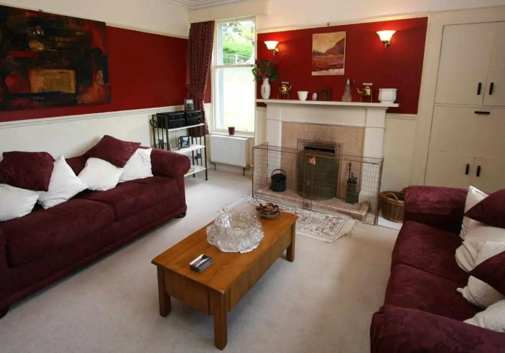 a living room with two couches and a fireplace at Cluny Mains in Newtonmore