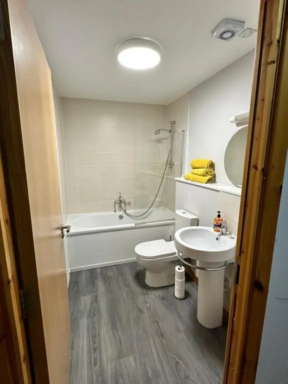 a bathroom with a tub and a toilet and a sink at Metro 8 Inverness City Centre in Inverness