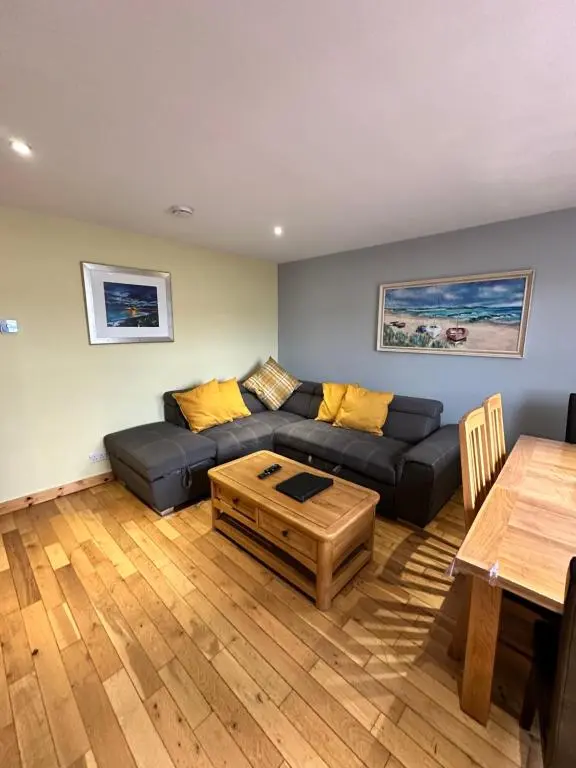 a living room with a couch and a table at Metro 8 Inverness City Centre in Inverness