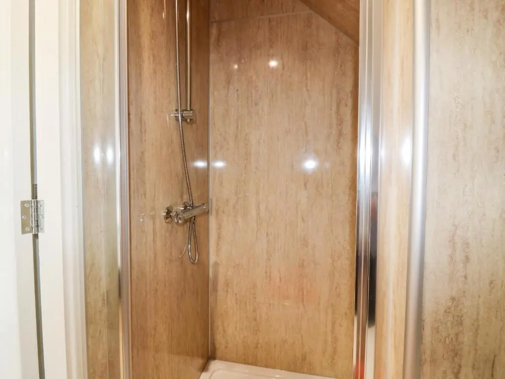a shower with a glass door in a bathroom at 111A Main Street in Banff