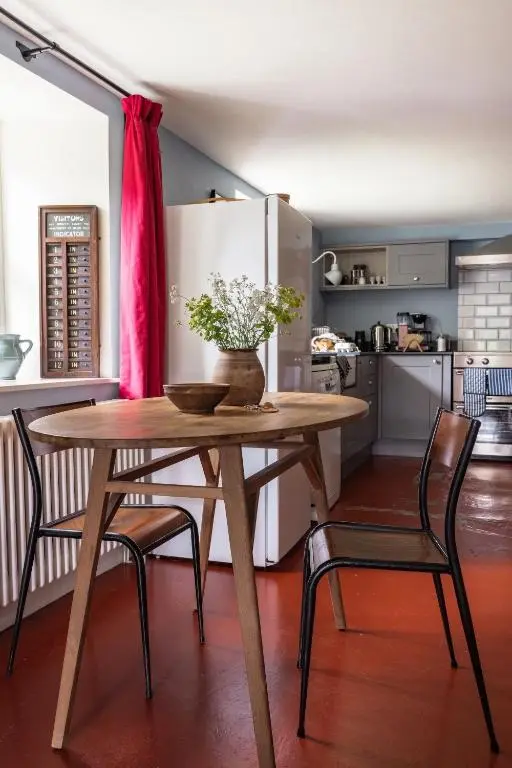 a kitchen with a wooden table and two chairs at Exclusive use - The Coach House in Banchory