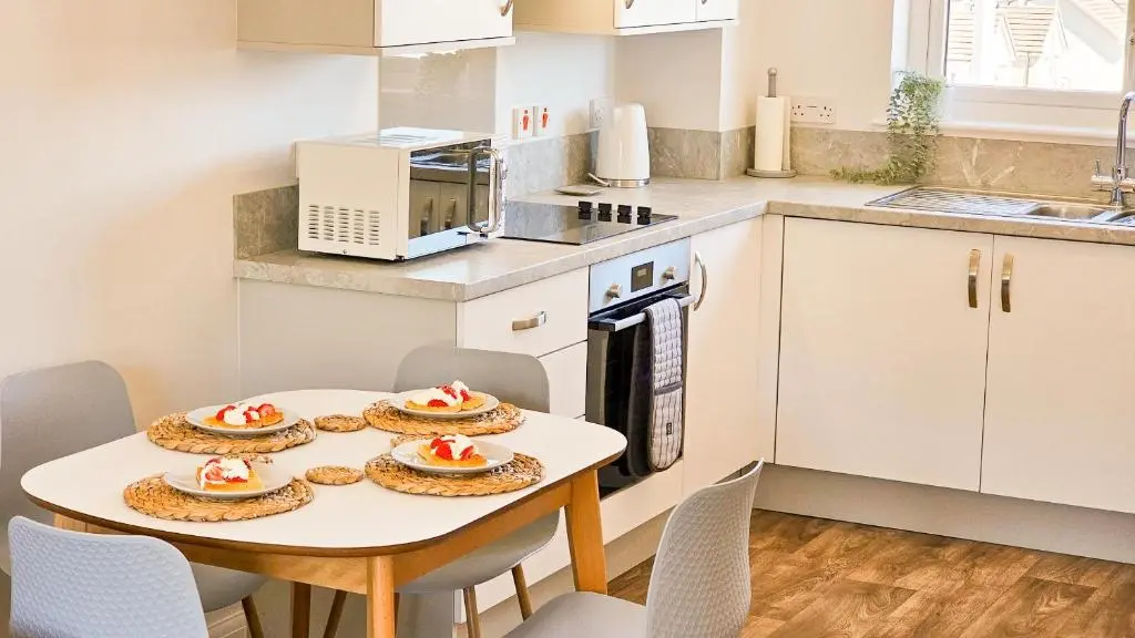a kitchen with a table with plates of food on it at 4 Ben Avon in Aviemore