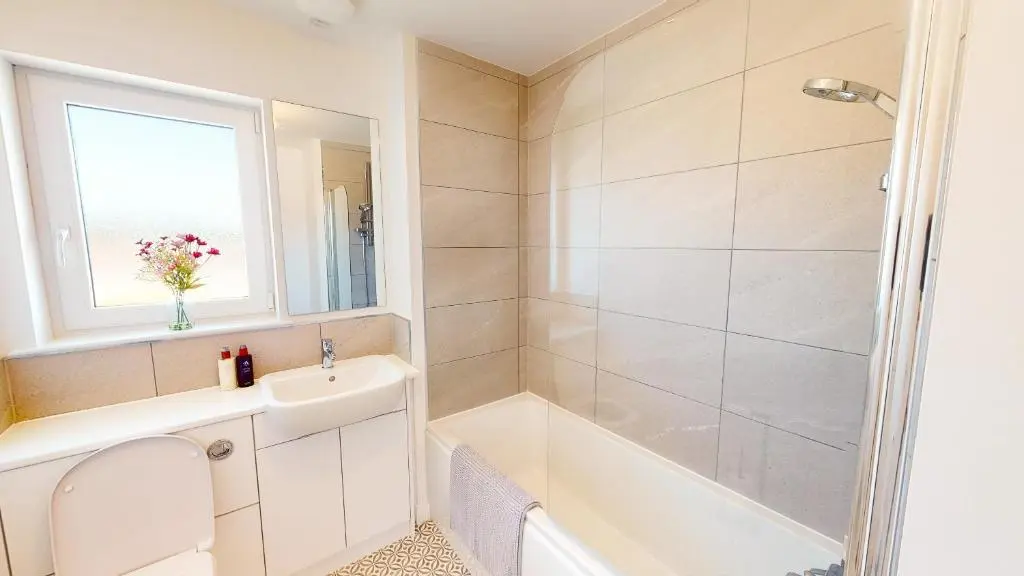a bathroom with a tub and a sink and a toilet at 4 Ben Avon in Aviemore