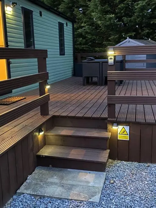 a wooden deck with stairs next to a house at Perfect for country lovers in Grantown on Spey