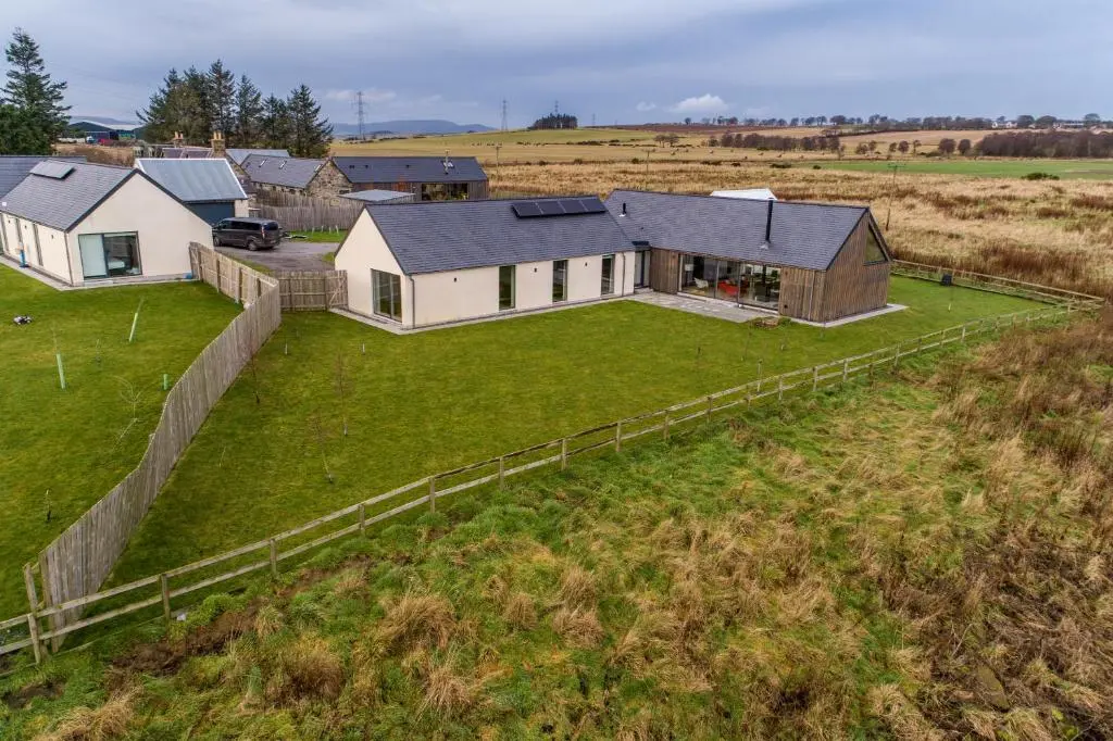 an aerial view of a house in a field at The Den, Architect Designed Barn, Beautiful Location in Kirkton of Skene