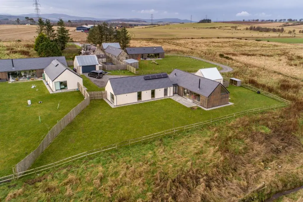 an aerial view of a house in a field at The Den, Architect Designed Barn, Beautiful Location in Kirkton of Skene