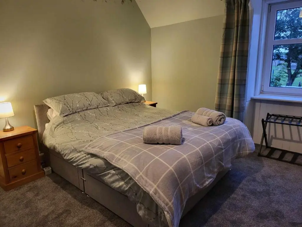 a bedroom with a bed with two pillows on it at 16 Northcote Street, Wick in Wick