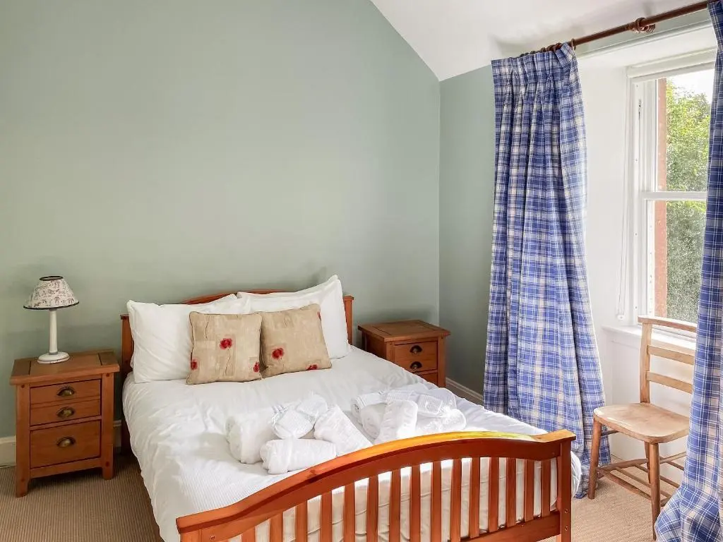 a bedroom with a bed with towels on it at The Old Manse - Ukc6854 in Millton of Clova