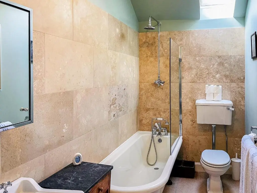 a bathroom with a tub and a toilet and a sink at The Old Manse - Ukc6854 in Millton of Clova