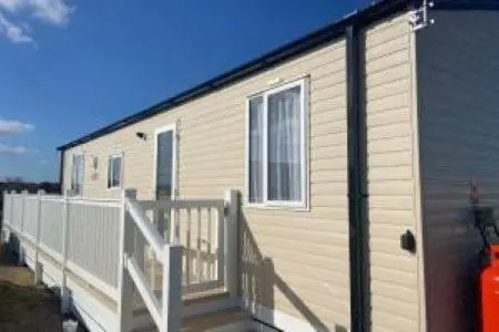 a mobile home with a porch and a deck at Silver sands holiday park in Lossiemouth