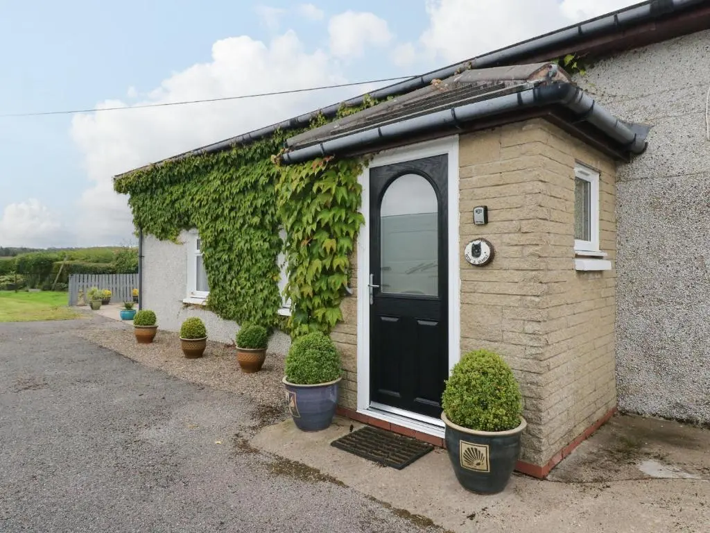 a house with plants on the side of it at Bide-a-While in Marnoch