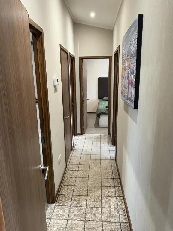 a hallway with several doors and a tile floor at Clochnaben lodge in Strachan