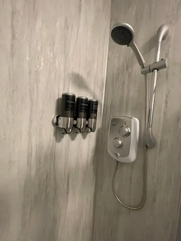 a shower with two cameras on the wall at Crown \u00e0ros beag, Ultra City Central 2 bedroom apartment with free parking onsite in Inverness